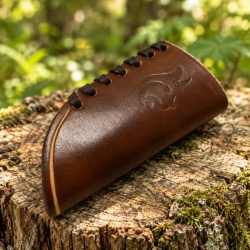 Brown leather axe handle protector with leather lacing on a woodland stump