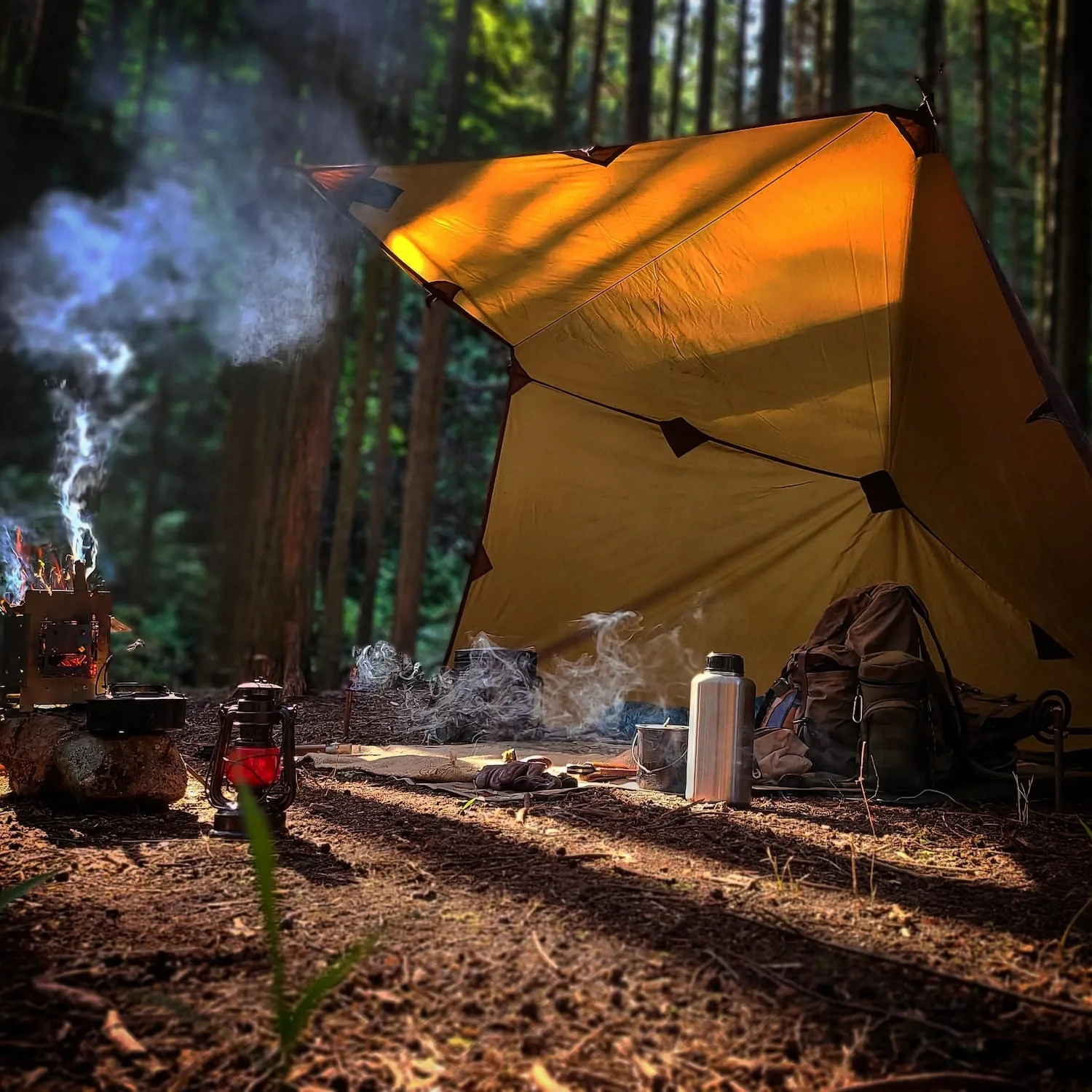 An oilskin tarp shelter beside the campfire