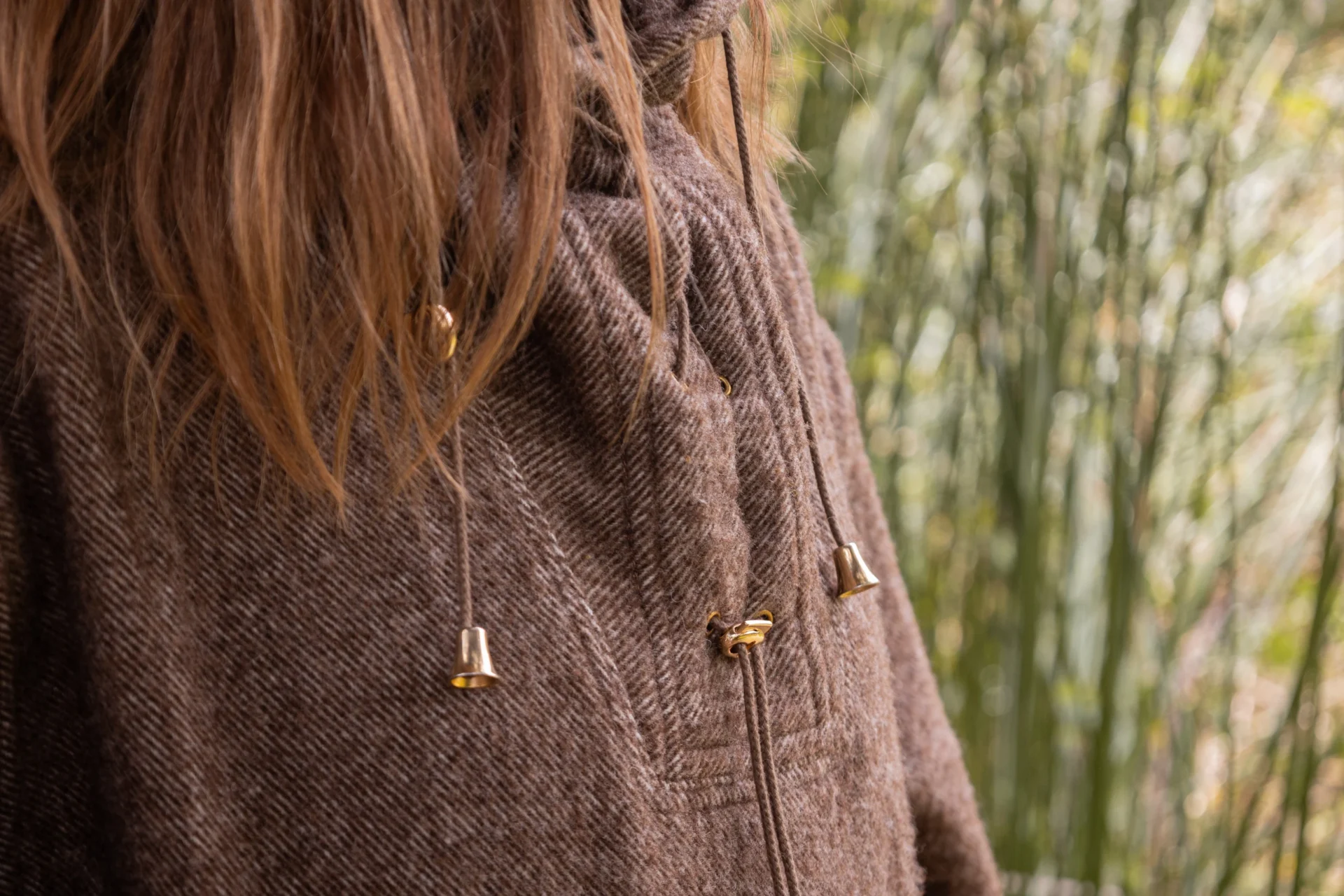 Detail of a wool poncho and its brass fastenings