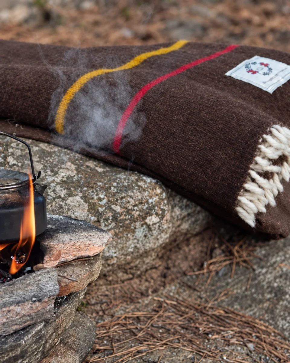 Brown striped merino wool blanket beside a campfire