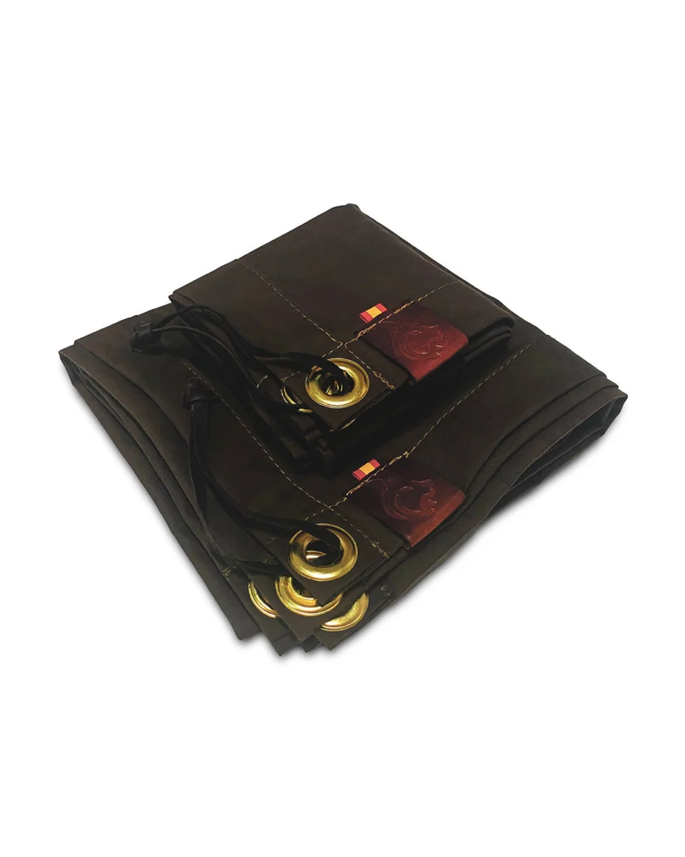 Folded brown oilskin camp mat with brass grommets