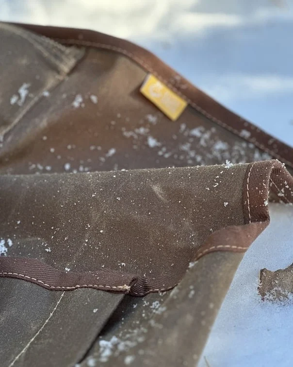 Close view of the Cowboy Bedroll waxed cotton fabric in the snow